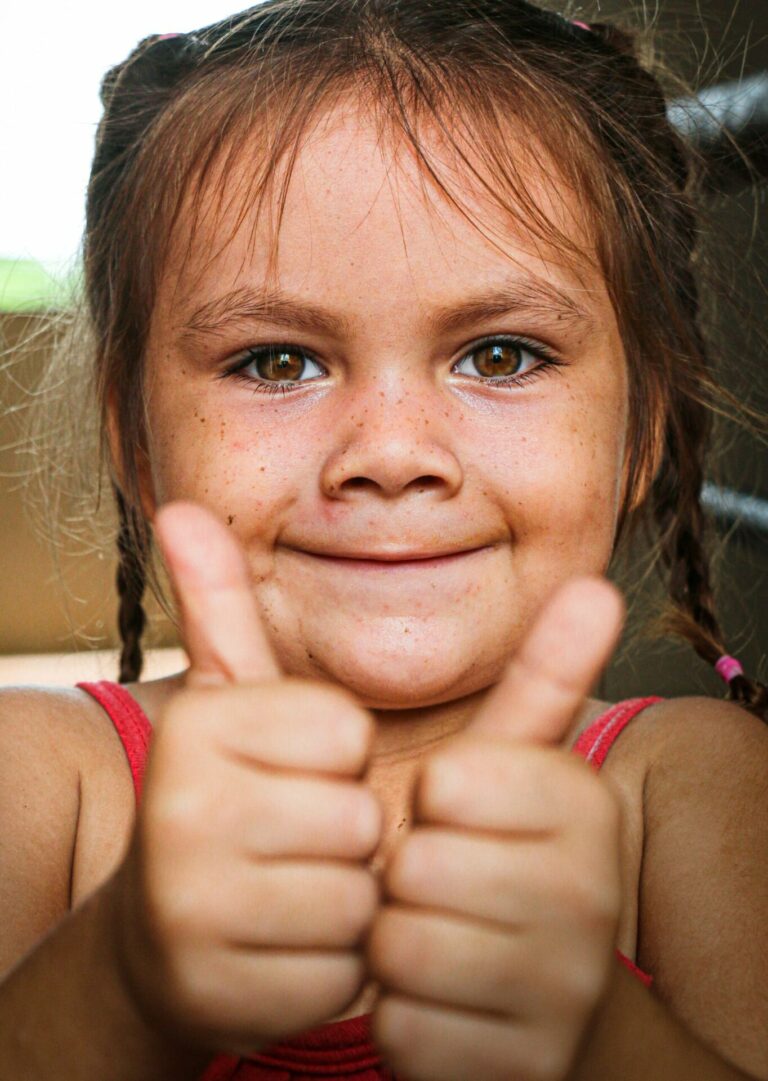 A photo of a girl with two thumbs up as if she likes or loves her body